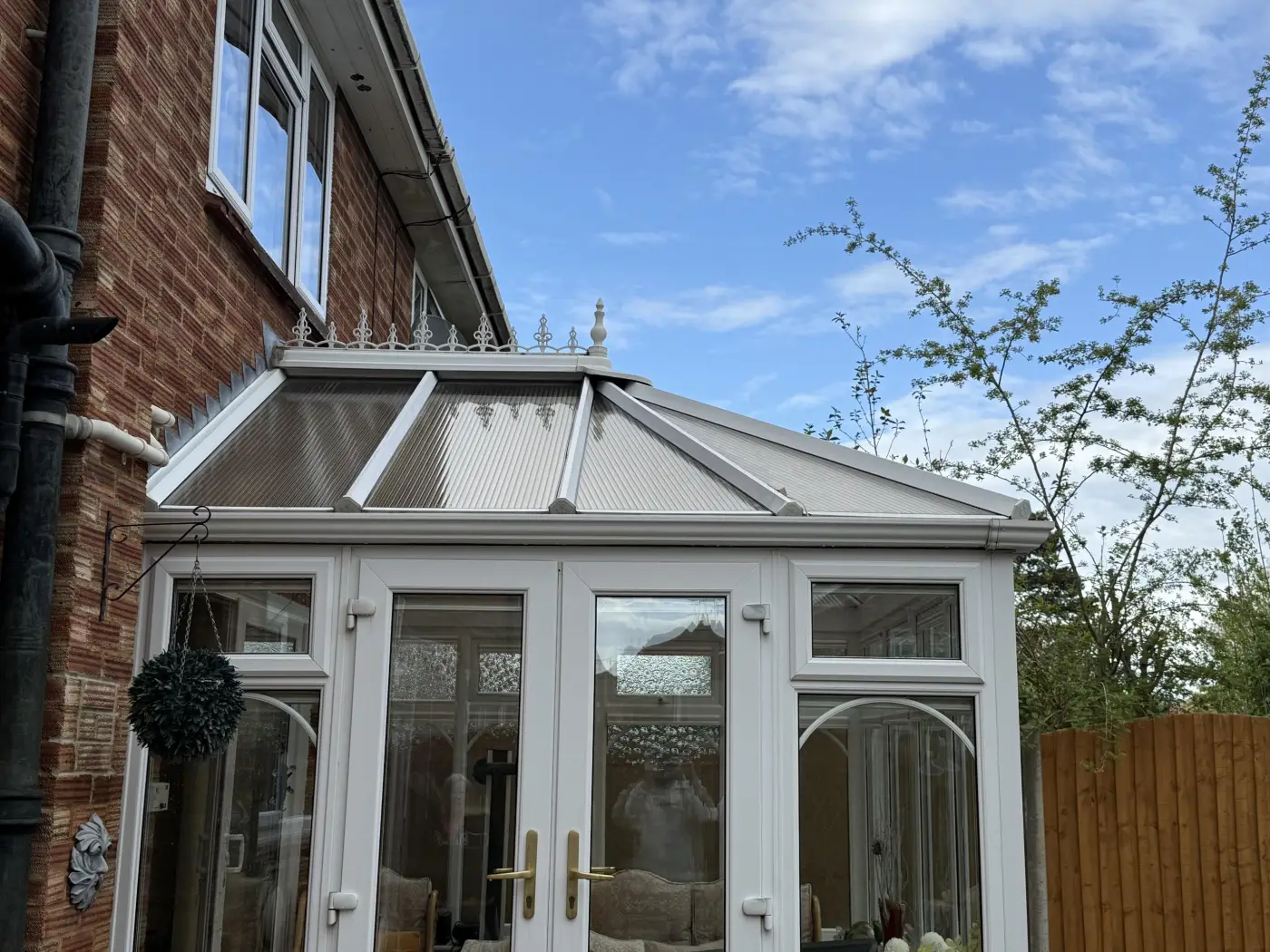 Clean white uPVC conservatory with a polycarbonate roof