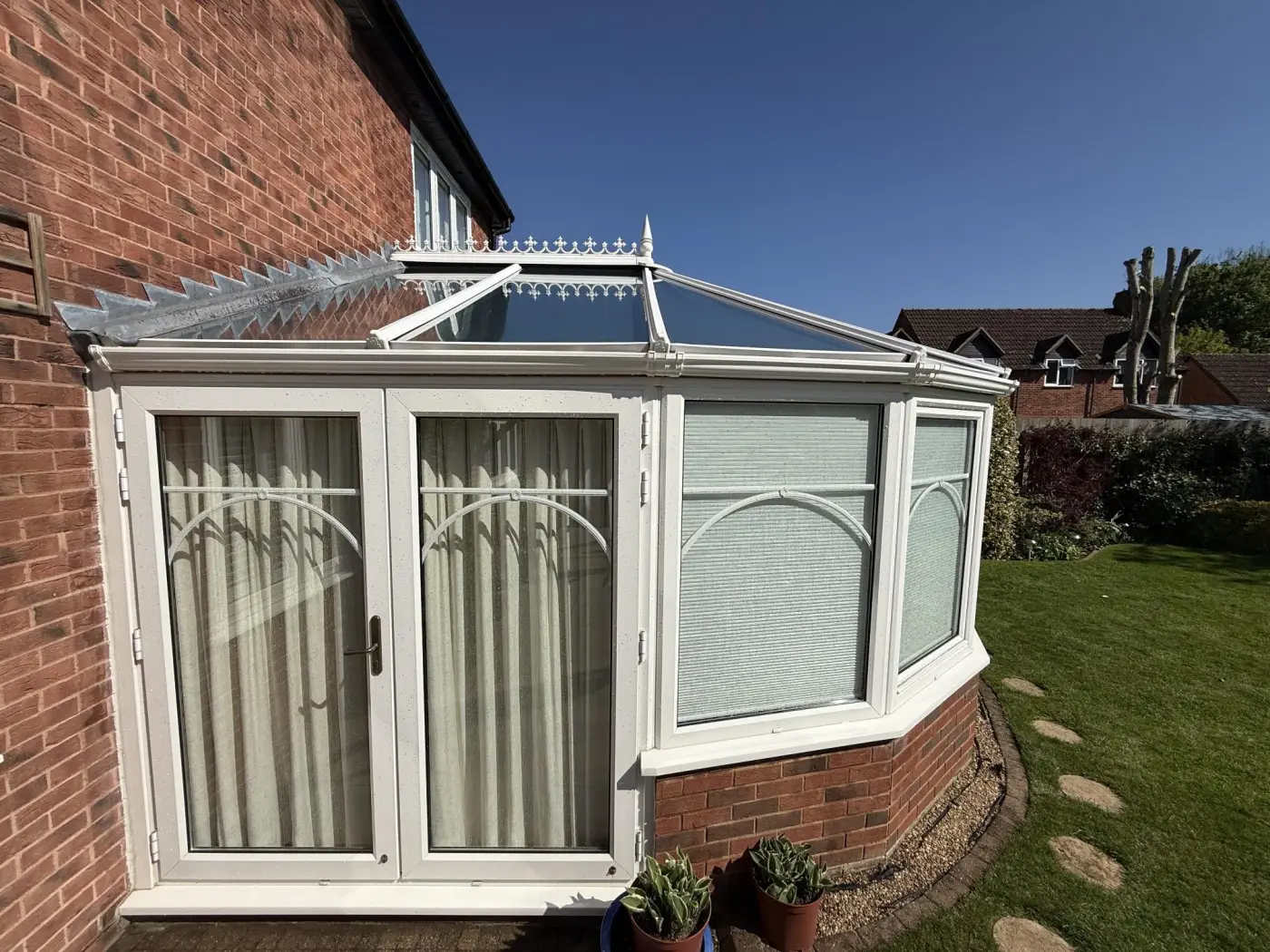 Clean conservatory beside a residential garden