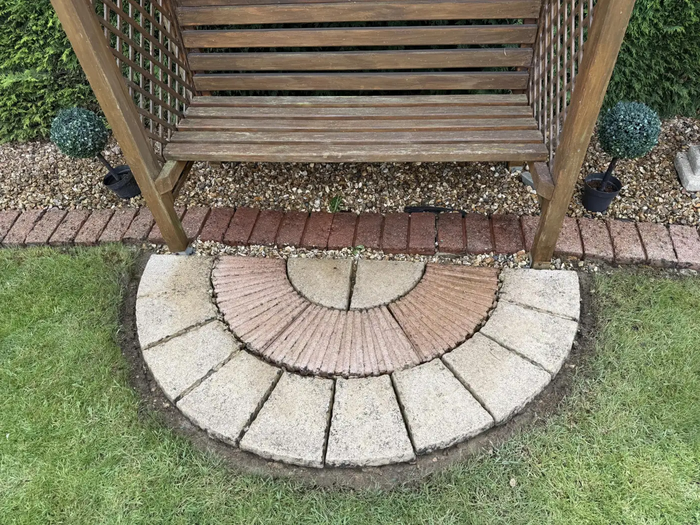 Clean patio paving beside a garden seat