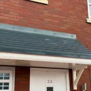 Front door and tiled roof of a brick residential property