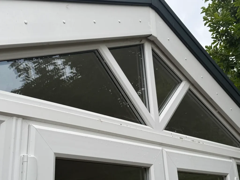 High triangular window panes and white frames at the Longford property