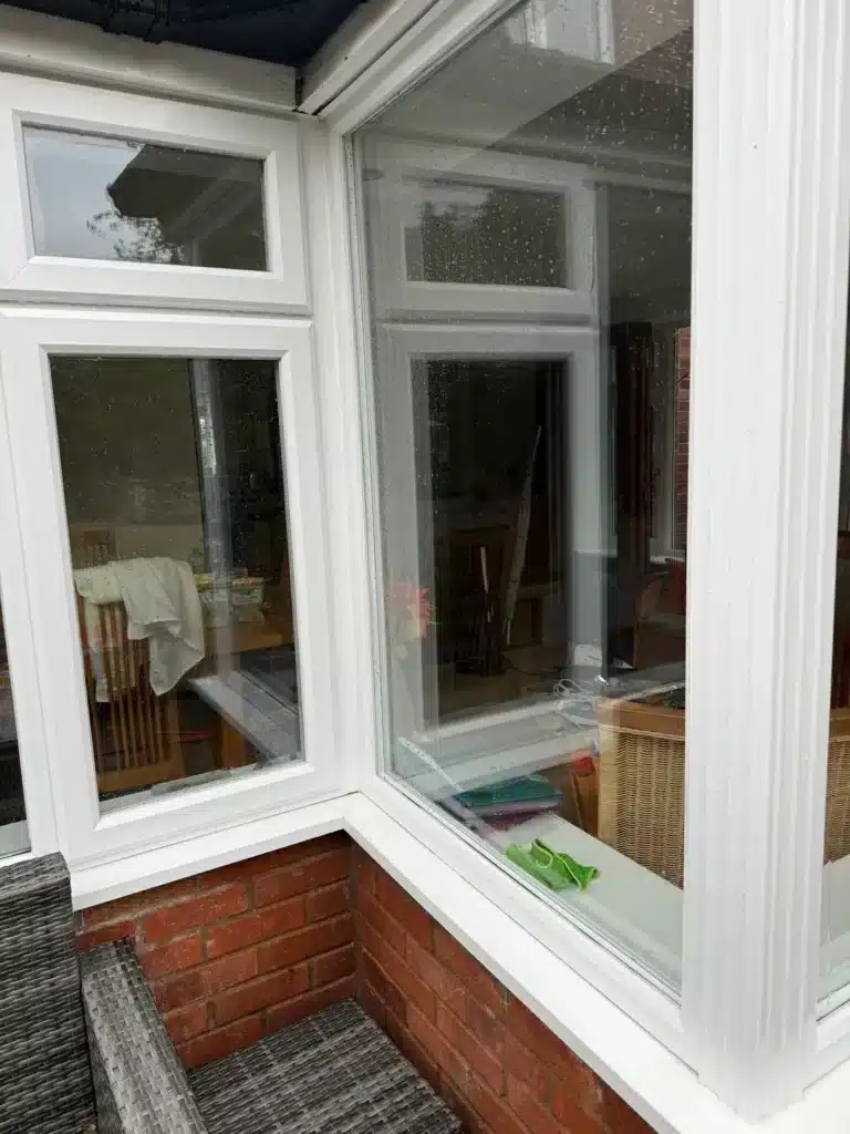 Glass, white window frames and sills being cleaned at a property in Longford Gloucestershire