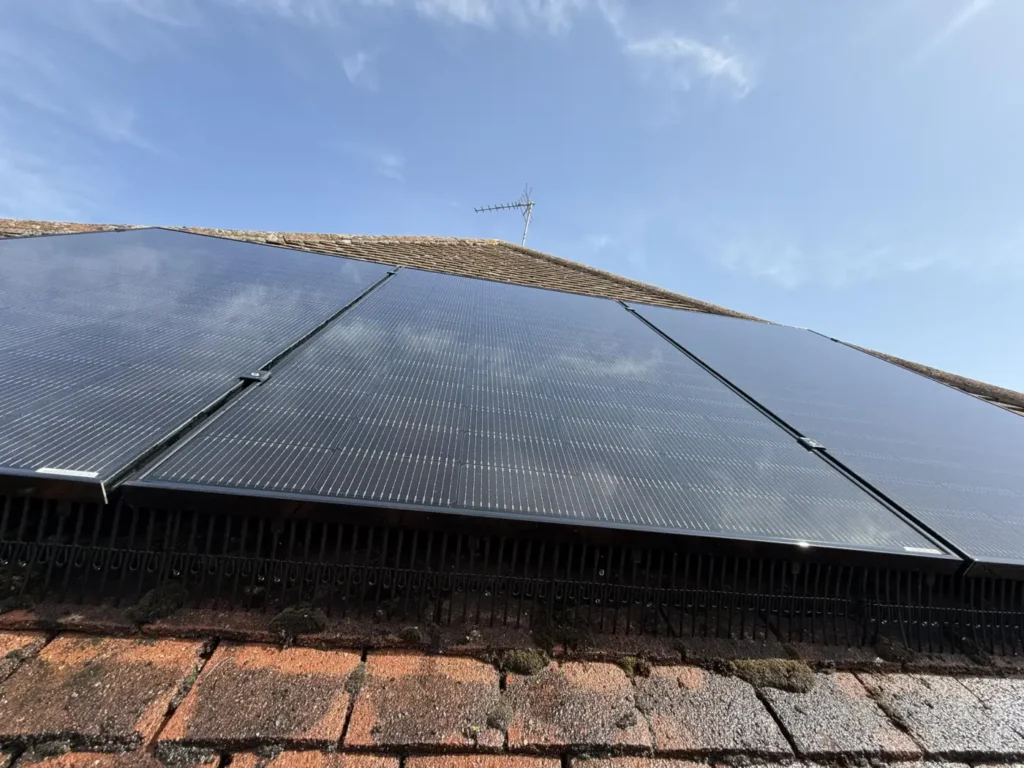 Close view of clean solar panel glass, frames and lower edges on a tiled roof